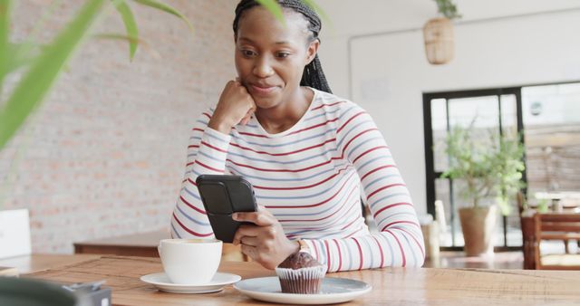 Woman Drinking Coffee Holding Smartphone in Cozy Cafe - Download Free Stock Images Pikwizard.com