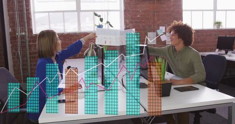 Two Business Professionals Analyzing Data with Graphs Overlay