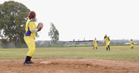 Female softball team practicing at suburban park