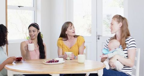 Diverse Group of Women Enjoying Summer Brunch in Sunlit Kitchen