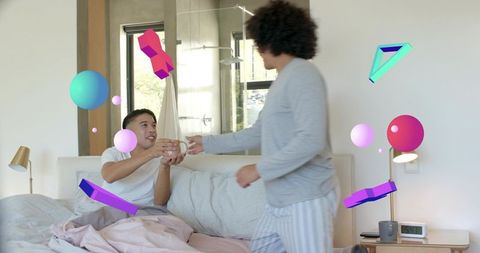 Couple sharing morning coffee in bed while handing mug, colorful ar graphics, cozy pastel bedroom