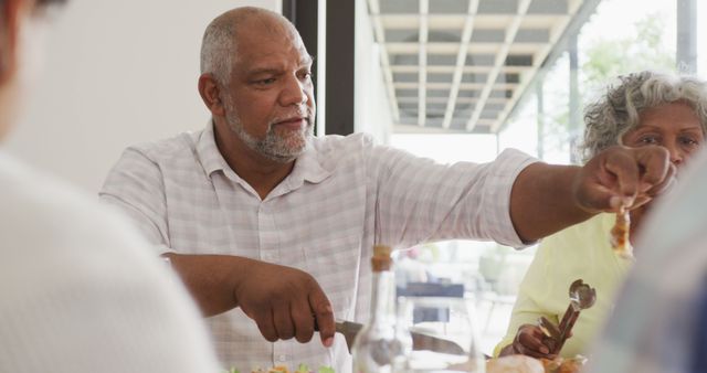 Senior Man Enjoying Lunch at Family Gathering Outdoors - Download Free Stock Images Pikwizard.com