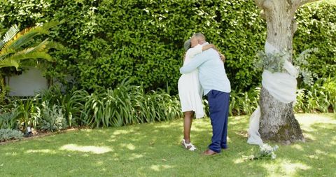 Senior Diverse Couple Embracing at Outdoor Wedding Ceremony