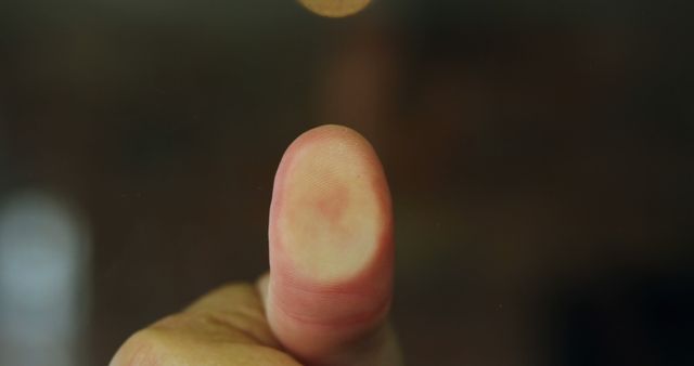 Thumb pressing on to glass for security in 4k