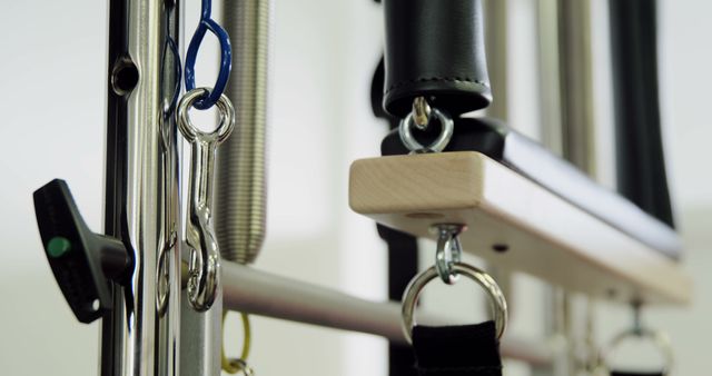 Close-up view of Pilates Reformer machine details. Ideal for use in fitness and wellness websites, exercise guide visuals, or gym promotional materials. Highlights the premium quality and professional setup of Pilates equipment, letting potential clients see the sophisticated design used in modern fitness routines.