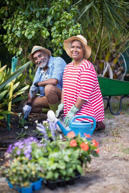 Senior couple enjoying gardening together in their yard. Ideal for use in articles about healthy aging, outdoor activities, gardening tips, and senior lifestyle. Perfect for promoting gardening products, senior wellness programs, and community gardening initiatives.