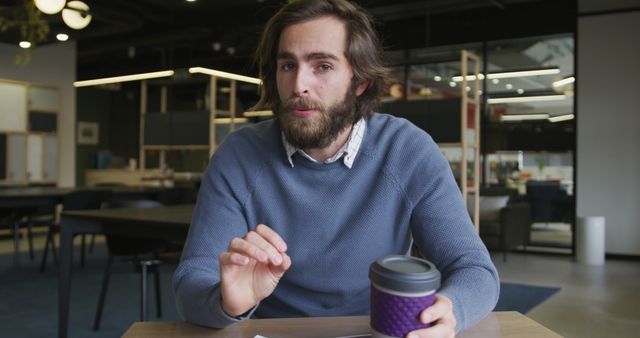 Man with Coffee Cup Discussing in Modern Office - Download Free Stock Images Pikwizard.com