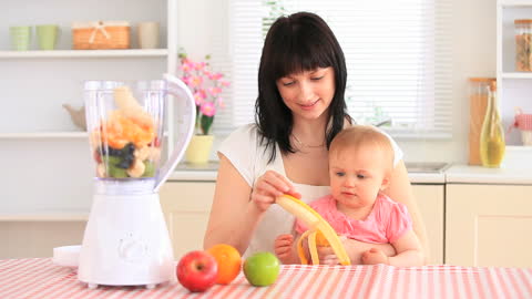 Mother and Baby Making Smoothie in Kitchen