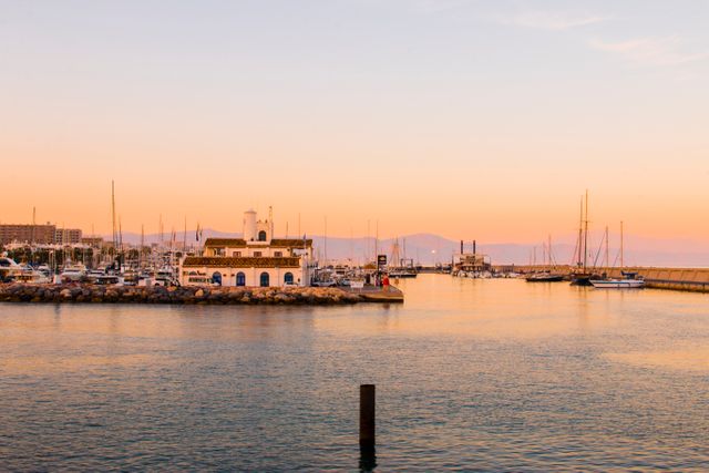 Serene Marina Sunset with Docked Yachts and Colorful Sky - Download Free Stock Images Pikwizard.com