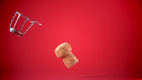Champagne Cork in Motion Against Vibrant Red