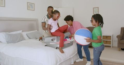 Family Packing Together for an Exciting Vacation Trip