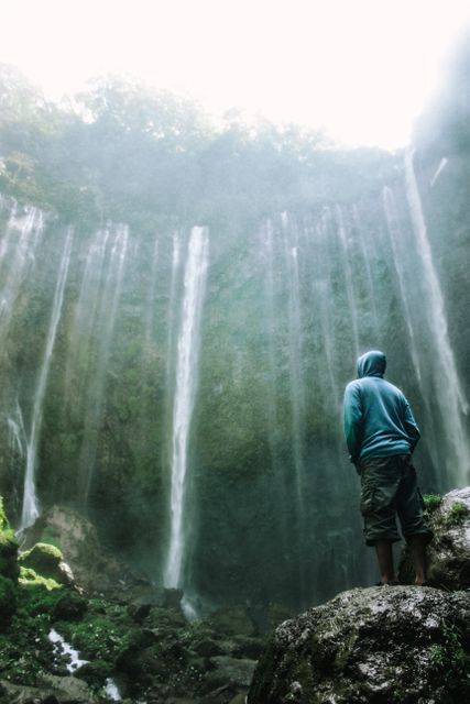 Solitary Traveler Standing by Waterfall Mist - Download Free Stock Images Pikwizard.com