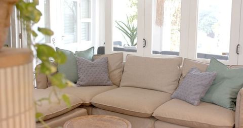 Cozy modern living room with beige sectional sofa and natural elements