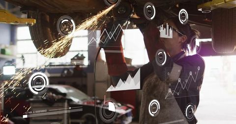 Female mechanic grinding under car with sparks and augmented reality performance overlays