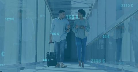 Business Travelers Walking Glass Airport Concourse With Digital Data Overlay and Rolling Luggage