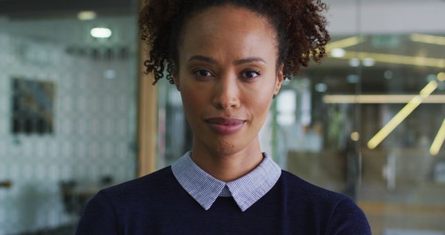 Confident Smiling Biracial Businesswoman in Blue Jumper Standing in Modern Office - Download Free Stock Images Pikwizard.com