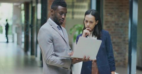 Professional Team Collaborating in Modern Office Corridor