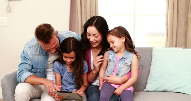 Happy Family Using Tablet Together in Living Room - Download Free Stock Images Pikwizard.com