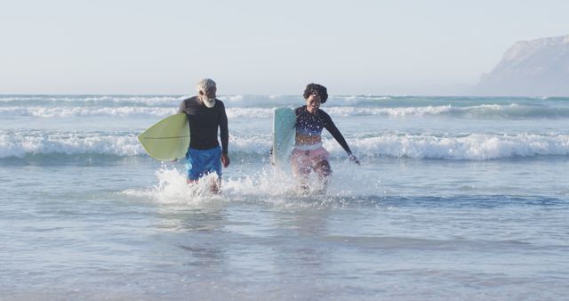 Couple Playing on the Beach with Body Boards in Sunny Weather - Download Free Stock Images Pikwizard.com