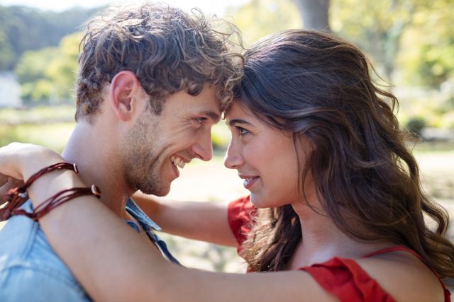 Romantic Couple Embracing in Park on Sunny Day - Download Free Stock Photos Pikwizard.com