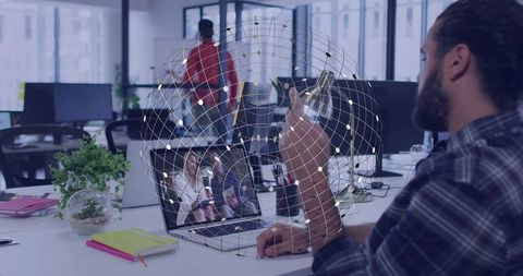 Developer collaborating with remote team using augmented reality globe in open office