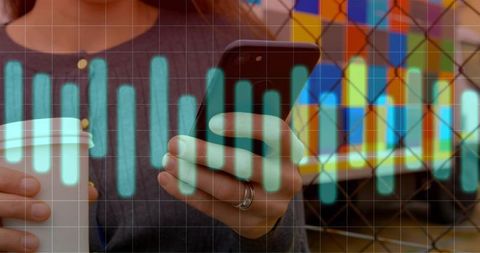 Businesswoman engaging with smartphone overlaid with data visualization graph