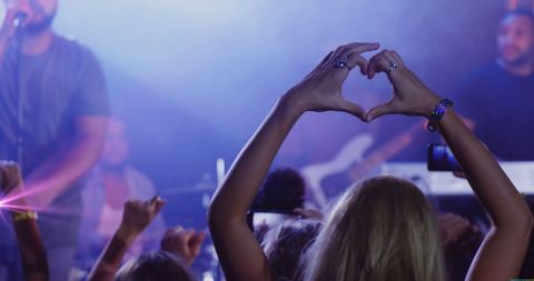 Caucasian Woman Making Heart Shape at Lively Concert - Download Free Stock Images Pikwizard.com