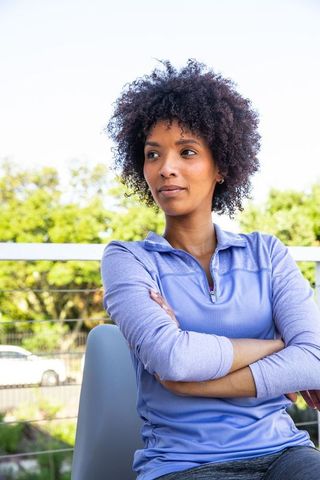 Confident African American Woman Relaxing Outdoors in Athletic Wear