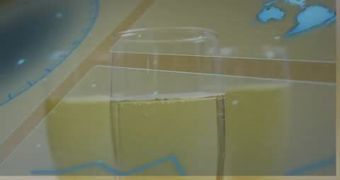 Camera shifting into focus on clear drinking glass with bubbles and holographic data overlay