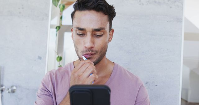 Man Brushing Teeth While Using Smartphone at Home Bathroom - Download Free Stock Images Pikwizard.com