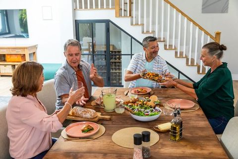 Senior Friends Enjoying Meal at Home in Comfortable Setting