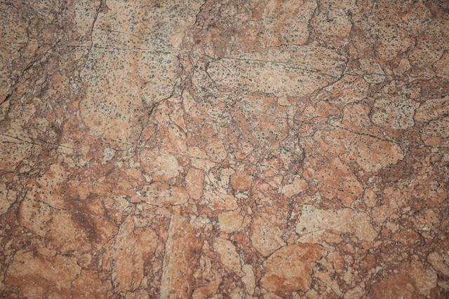 This close-up of an old textured wall background is perfect for use in design projects requiring a rustic or vintage feel. The natural stone texture and earthy tones make it suitable for backgrounds, wallpapers, and architectural presentations. It can also be used in marketing materials for construction or interior design businesses.