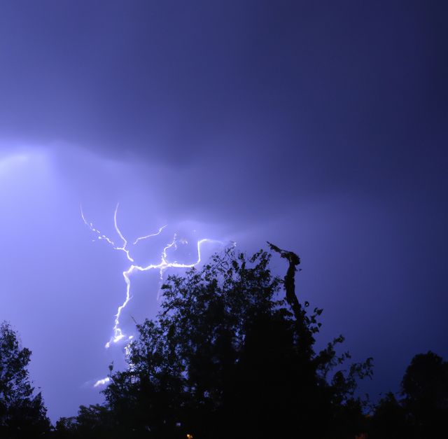 Image of thunder lightning against blue stormy sky with copy space. Nature, storms and weather concept.