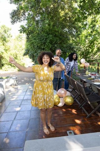 Friends decorating patio with balloons for vibrant outdoor celebration