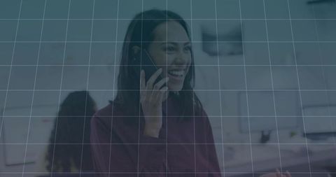 Smiling Woman Engaged in Office Communication on Smartphone