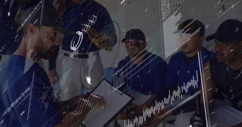 Coach Analyzing Data with Baseball Team in Locker Room