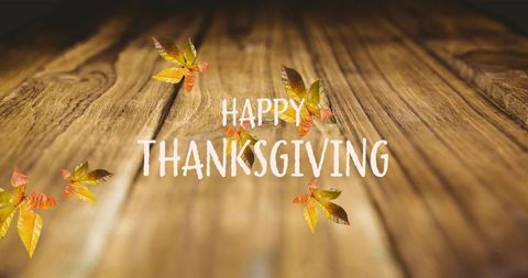 Happy thanksgiving rustic wooden background with autumn leaves and minimalist greeting
