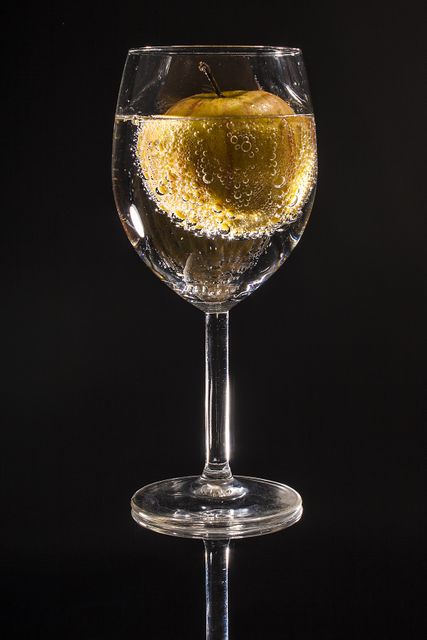 Apple Floating in Sparkling Water in Wine Glass on Black Background - Download Free Stock Photos Pikwizard.com