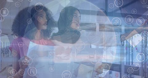 Diverse Businesswomen Collaborating Overlaid with Tech Icons