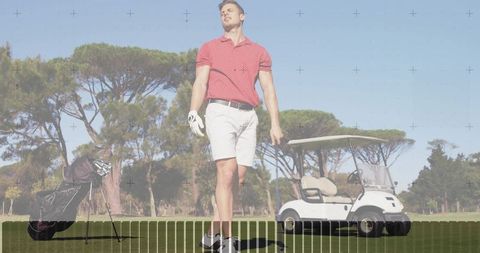 Striding golfer wearing red polo and white shorts on sunny fairway with golf cart