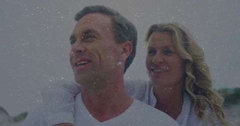 Joyful Mature Couple Embracing at Beach with Retro Effect