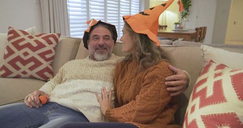 Couple Enjoying Cozy Autumn in Festive Pumpkin Hats
