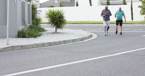 Friends strolling outdoors with prosthetic leg and water bottles