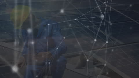 Engineer Analyzing Solar Panels with Network Connections Overlay