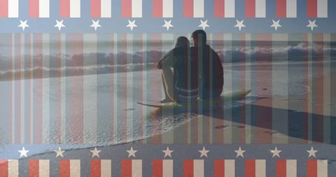 Couple sitting on surfboard watching ocean with american flag overlay at sunset