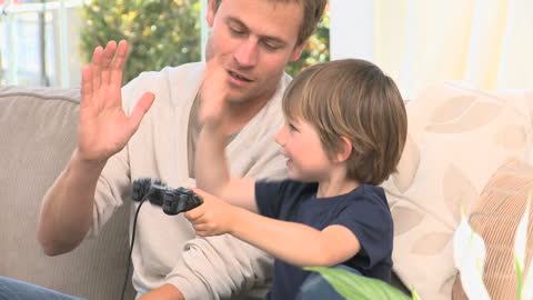Father and Son Enjoy Video Game Enthusiasm Together
