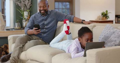 Father and Daughter Bonding Through Technology at Home