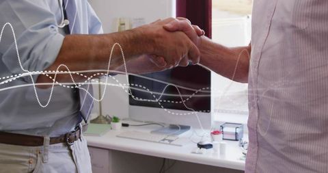Business handshake in office with waveform overlay symbolizing data-driven partnership