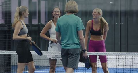 Friends Enjoying Fun Match on Padel Court in Casual Sportswear