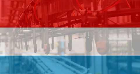 Netherlands Flag Over Modern Factory Background